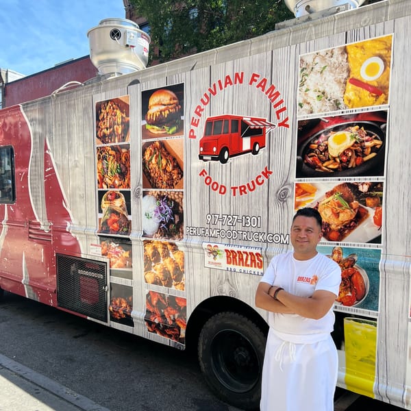 Chef in white uniform stands proudly beside the Brazas BBQ Chicken Peruvian food truck.